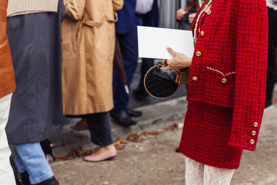 Chanel Paris Fashion Week Street Style - women in red outfit holding a small black handbag 