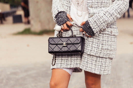 Closeup of small back handbag, woman standing on the street wearing a white outfit - Chanel Paris Fashion Week Street Style