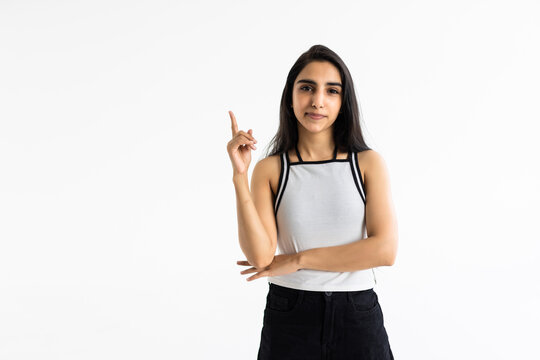 young indian woman wearing casual clothes over white studio background showing and pointing up with finger have idea