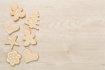 Obraz na płótnie Canvas Cute homemade Christmas cookies on wooden background,top view