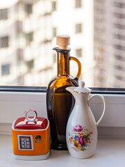 Containers for oil, vinegar and spices on the windowsill - 661620612