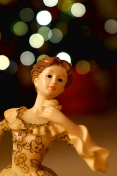 Close-Up of a angel doll  on bokeh lights blurred background. Decoration on Christmas holidays. Doll on the background of the christmas tree.