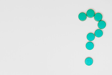 plastic bottle caps in the shape of a question mark with copy space on a white background concept recycle agenda 2030