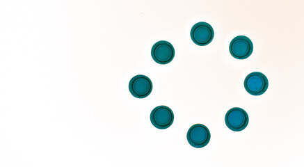 pile of plastic bottle caps in the shape of a circle with copy space on a white background recycle agenda 2030 concept