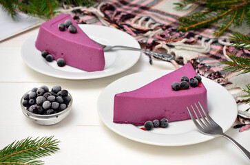 still life with a colorful purple dessert with blueberries on the table