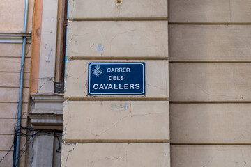 Valencia, Spain - September 22th, 2023: Information plaque on the wall of a building. One of the main historical walks of the city. Road sign depicting the street: Carrer dels Cavallers (València).
