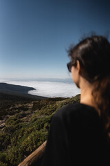 Fototapeta na wymiar female at high mountain and green forest over cloud cloudscape, Tenerife, Canary