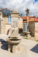 Fototapeta na wymiar Plaza with fountain and cruise in the beautiful fishing village of Combarro, in Pontevedra, Galicia