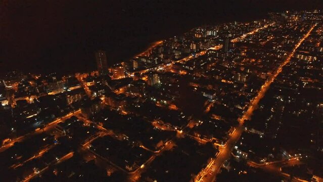 Cityscape, night and drone with landscape and travel, traffic and urban street with infrastructure and buildings. Road, Cape Town city lights, aerial view and skyscraper background with transport