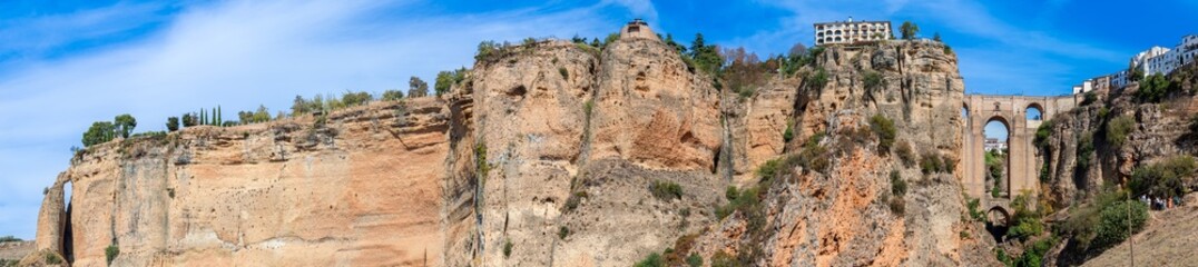 Panoramic view of Puente Nuevo Bridge on sunny day in Ronda, Spain