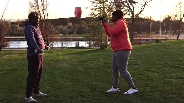 African American senior couple practicing boxing in the park