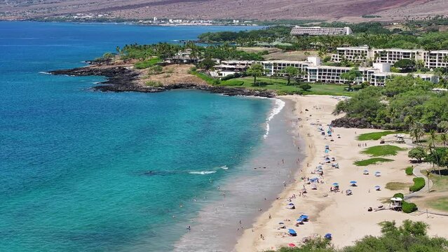 Aerial Kona Hawaii ocean coast beach resort 1. Big Island. Luxury exclusive homes on coast with golf course. Volcanic lava flow environment. Economy tourism. Tropical beach recreation.