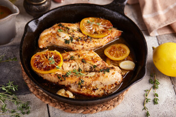 Chicken breast meat fillet roasted with thyme, lemon and mustard sauce. Delicious homemade poultry dish