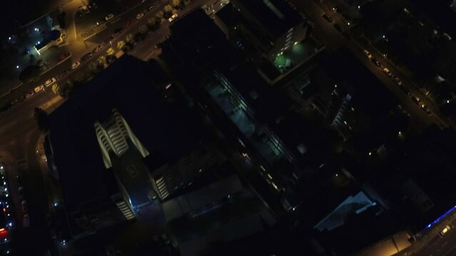 City, traffic at night and street light from a drone pov for travel, transportation or commute with commercial buildings. Cars, road and skyscraper architecture with movement through an urban town