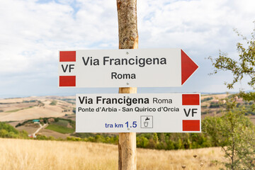 Via Francigena (pilgrim's route to Rome) way marker showing the direction to Rome, Ponte d'Arbia and San Quirico