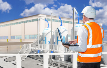 Energy industry. Man with laptop at hydrogen factory. Engineer inspects industrial enterprise....
