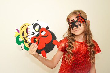 Halloween. Child in Halloween carnival mask. The child made handmade felt masks for Halloween. Kid...