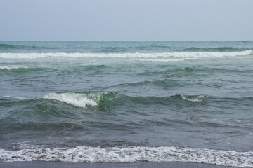 Seascape. View of the waves and surf. Windy weather. Waves, foam and ripples on the surface of sea...