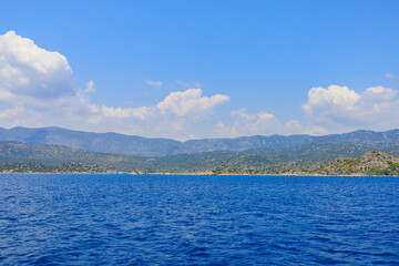Obraz premium View of the rocky shore from the sea. Mediterranean Sea in Turkey. Popular tourist places. Background