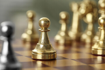Golden pawn on chess board, closeup. Space for text