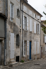 Fototapeta premium View on old streets and houses in Cognac white wine region, Charente, walking in town Cognac with strong spirits distillation industry, France