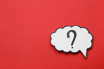 Paper speech bubble with question mark on red background, top view. Space for text