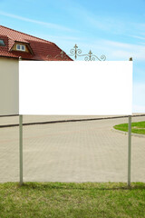 Decorated empty signboard outdoors. Mock-up for design