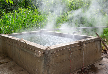 Stone pool mineral hot water for thai people and foreign traveler travel visit and cooking boiling eggs in San Kamphaeng Hot Springs onsen at  Chiang Mai, Thailand