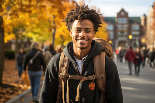 Portrait of black man on college campus with crowd of students behind