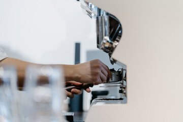 Barista making coffee in cafe