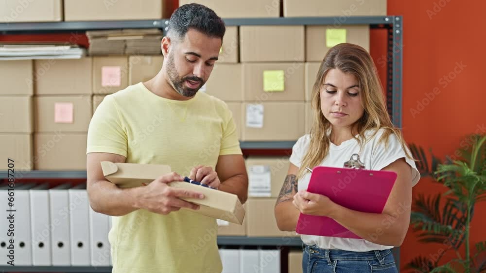 Sticker man and woman ecommerce business workers packing clothes on cardboard box writing on document at off