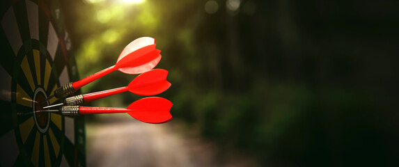 Bullseye or Bulls eye target or dartboard has dart arrow throw hitting the center of a shooting for...