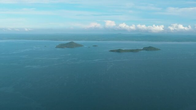 Tropical islands in the blue sea against the background of the sky and clouds. Philippines.