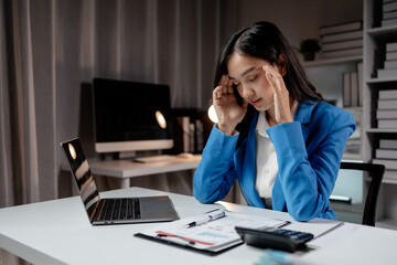 Asian women are stressed and tired from long hours of work, and businesswomen work hard causing...