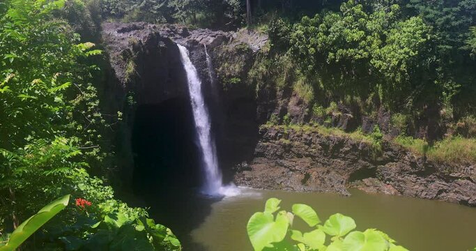 Rainbow falls Hilo Hawaii landscape. Big Island. Rain forest environment, landscape, river and stream with waterfalls. Beautiful green landscape and nature. Economy is tourism. Water.