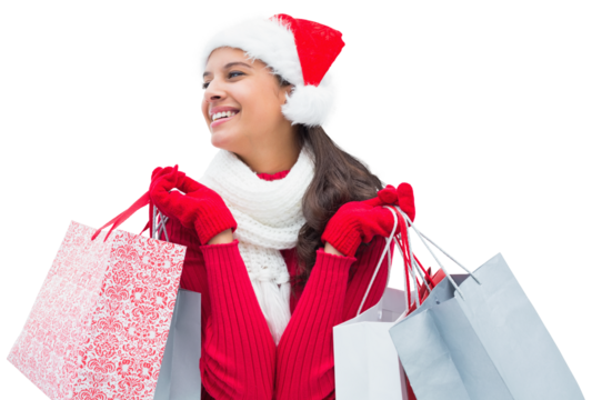 Digital png photo of happy woman in santa hat holding shopping bags on transparent background