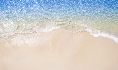 Summer sea natural background Beige surface, clear water with ripples and splashes. water waves in sunlight The water surface has waves.