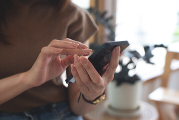 Close up of woman hand using mobile smart phone for online shopping and digital banking via mobile app, surfing the internet, social media network, people lifestyle