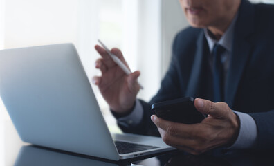 Asian businessman online meeting via laptop computer by online meeting app from office, video conference. Business man making a serious discussion with colleague on teleconference via laptop