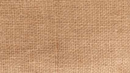 Hessian sackcloth burlap woven texture background, Cotton woven fabric close up with flecks of varying colors of beige and brown, with copy space for text decoration. Burlap texture