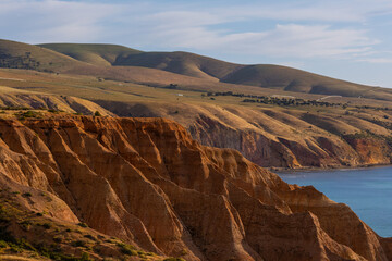Rock cliff and green hill of Sellicks Beach, South Australia.