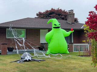 Inflatable figures of green Oogie Boogie and spider at web
