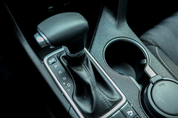 Automatic gear stick of a modern car, multimedia and navigation control buttons. Car interior...
