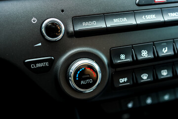 Modern car climate control panel for driver and passenger with shallow depth of field. Zone climate control. Car interior detail