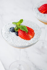 exotic fruit cocktails with berries and chia seed topping and mint side view