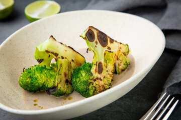 cooked broccoli in mushroom sauce and lime