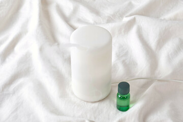 Aroma diffuser and essential oil on cloth.
