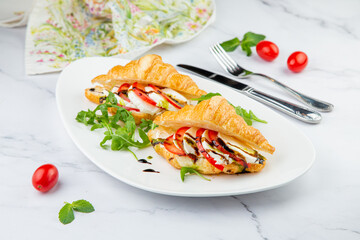 croissants with cheese, vegetables, cherry tomatoes and herbs