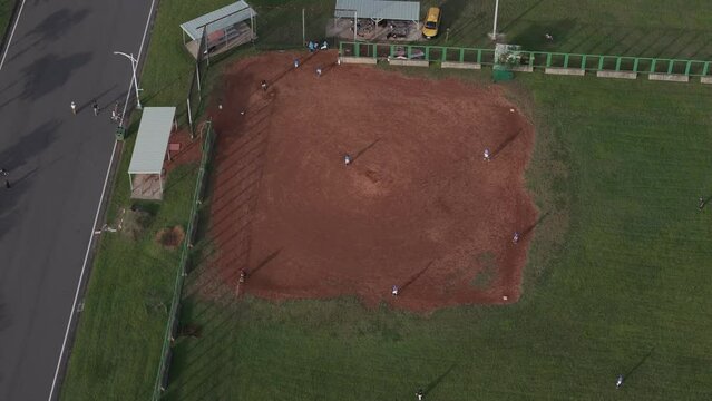 Aerial footage of baseball team training in the infield at Bali Shisanhang Cultural Park, Indonesia