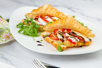 croissants with cheese, vegetables, cherry tomatoes and herbs